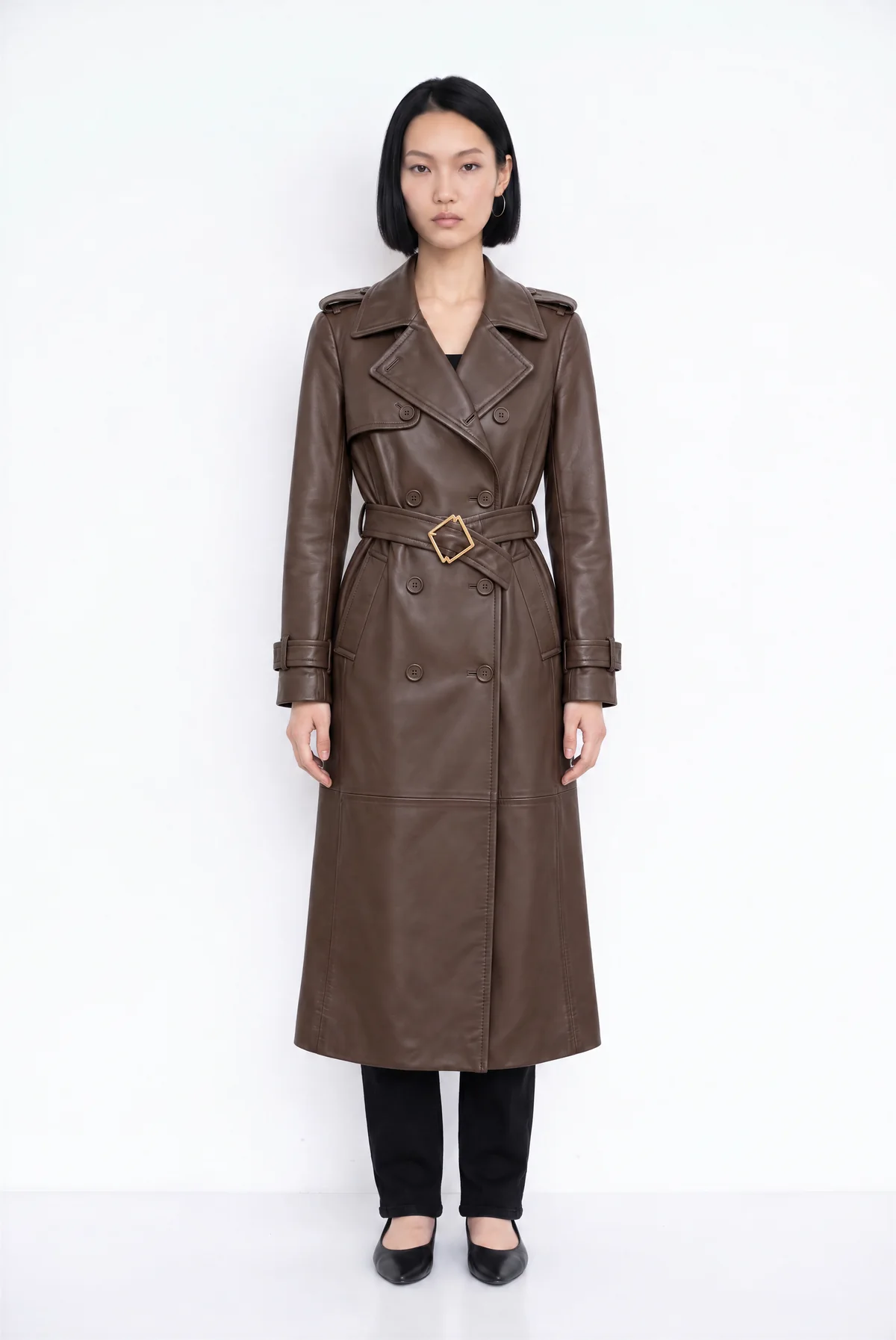 Front view from Agent: the model wearing the brown leather trench coat on a white background