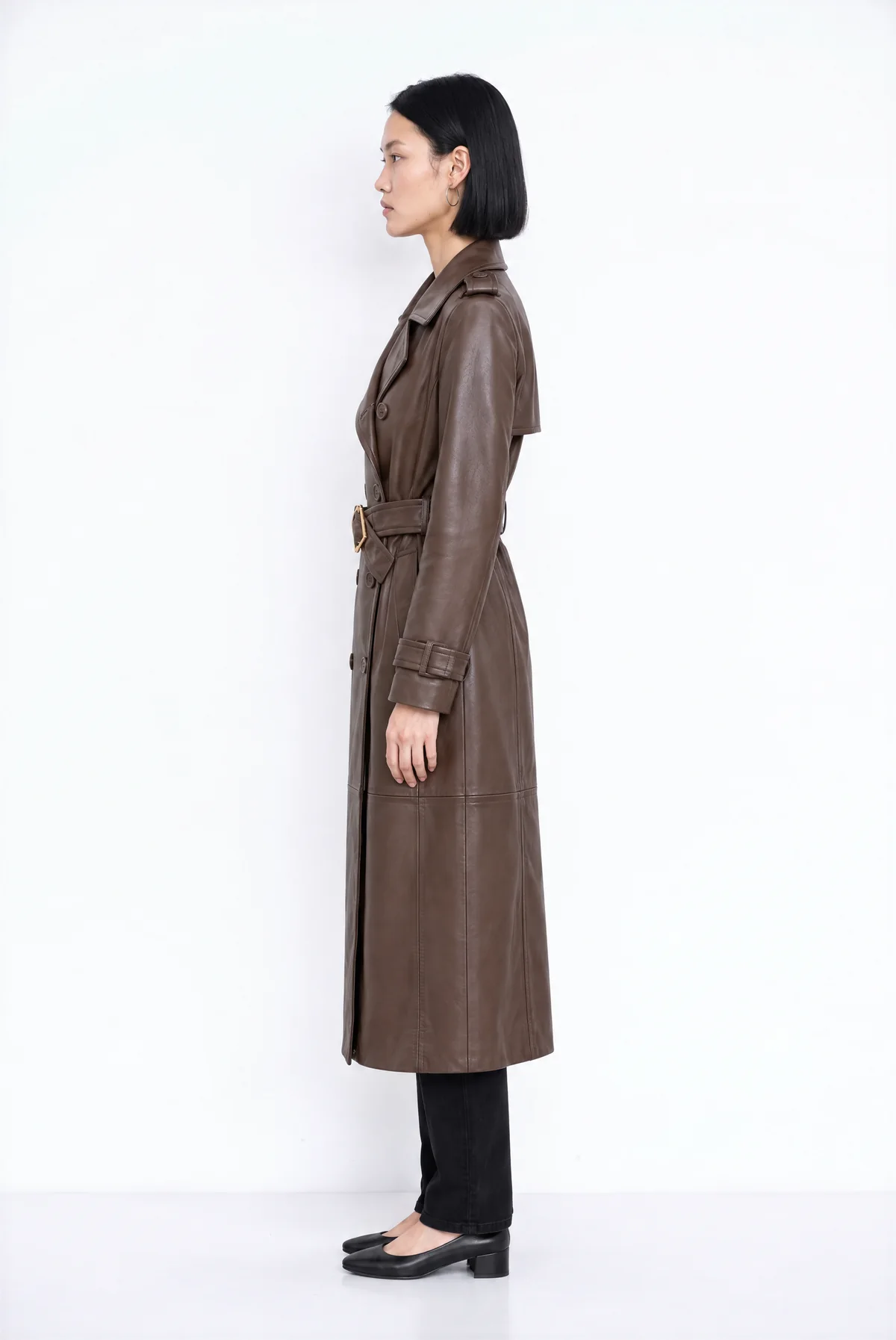 Side view from Agent: the model in the trench coat on a white background