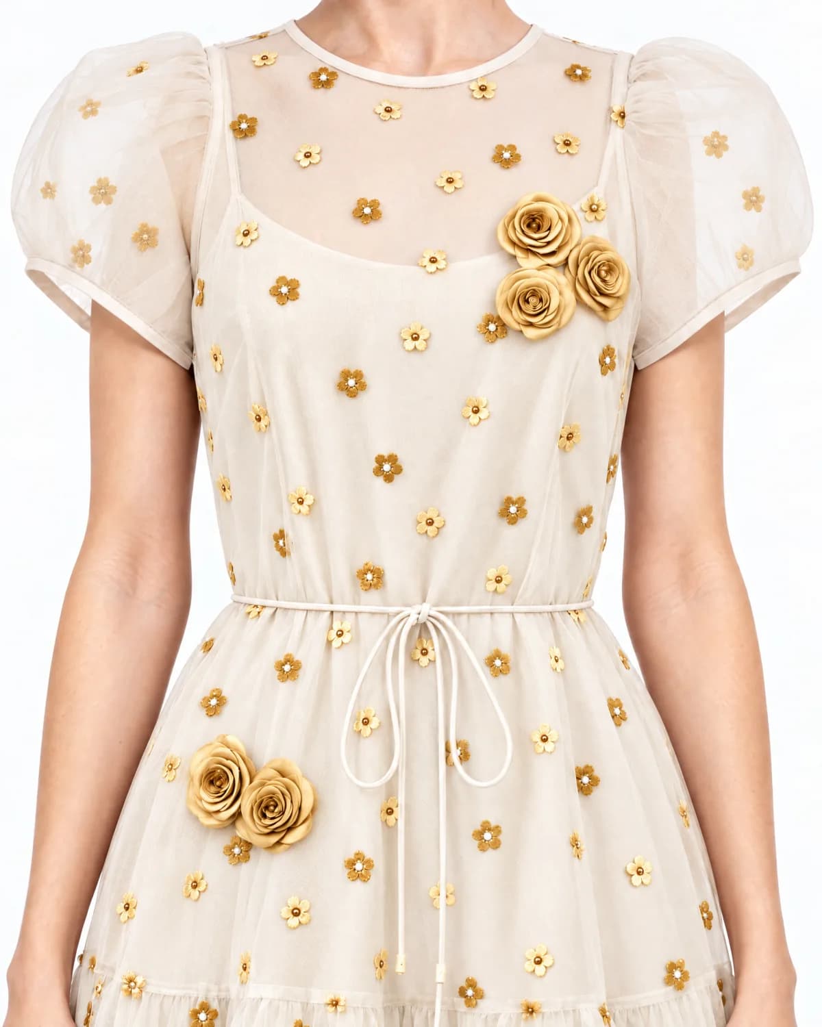 Close up of the ivory dress with gold roses and gold flowers, with no leaves