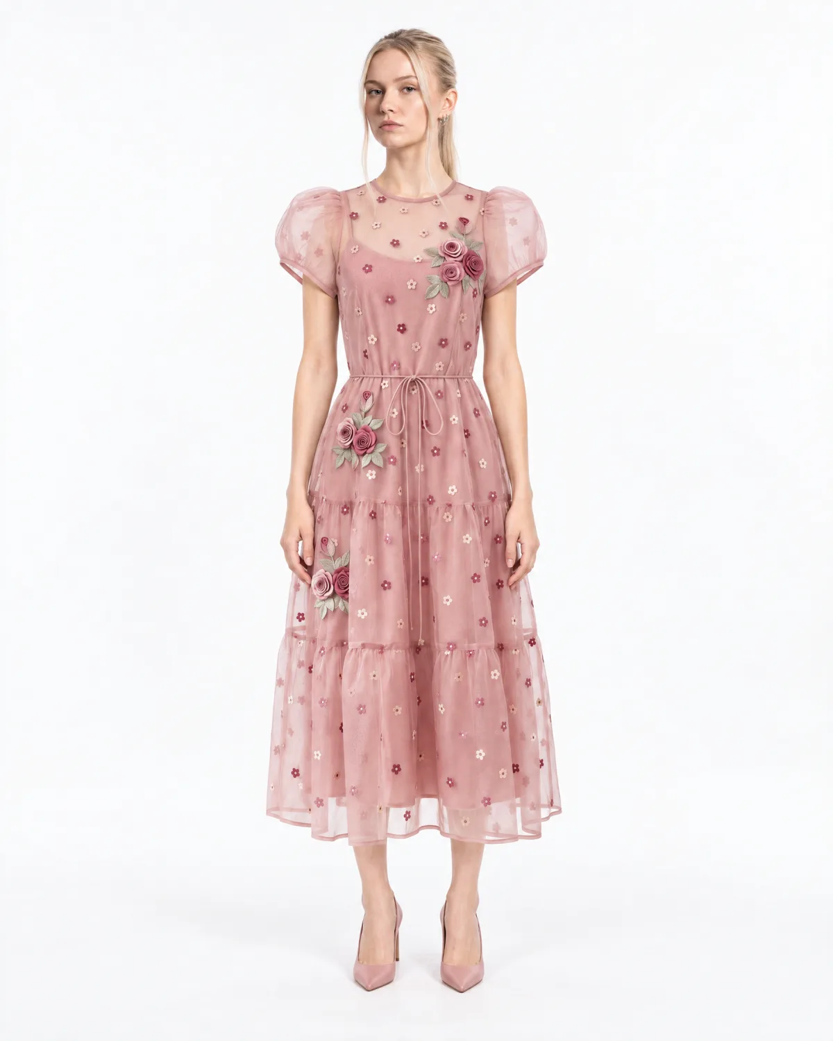 Front view: the model with the face from the portrait wearing the pink dress and the pink heels on a white background