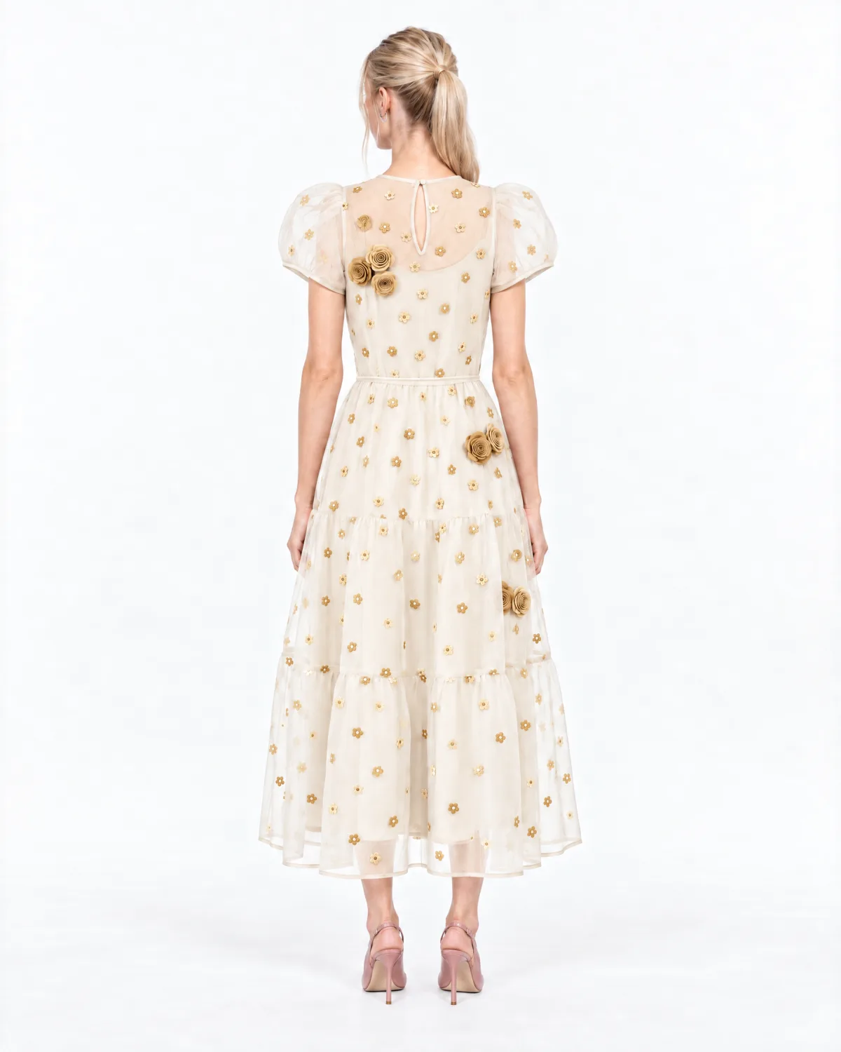 Back view of the same model in the ivory dress with gold flowers