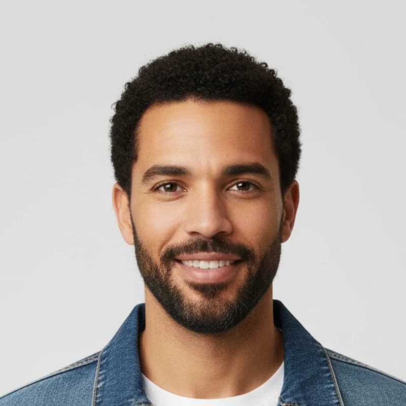 Close up of a 1K image: a man with curly hair and a trimmed beard, with soft skin and blurred hair