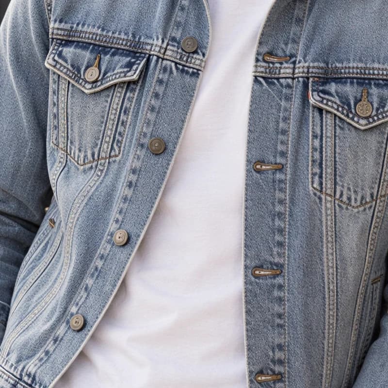 The same close up upscaled 2×: a clear denim weave, sharp seams, and clean buttons