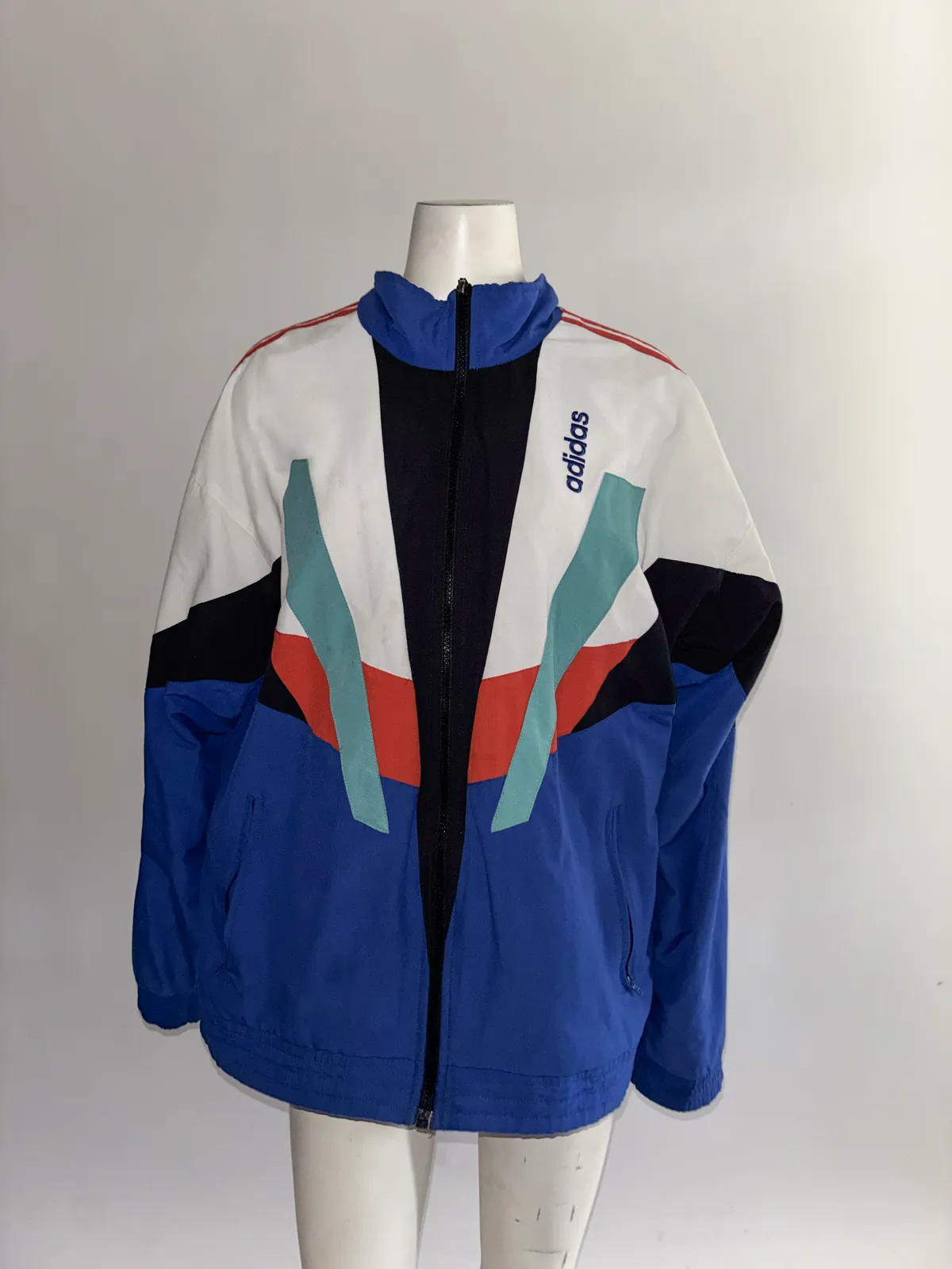 The jacket on a mannequin lit by a phone flash, evenly lit with no shadows