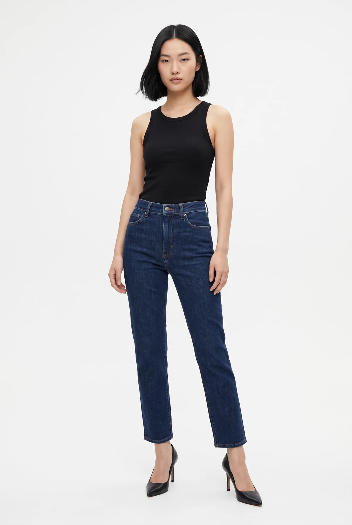 The model: an East Asian woman with a short black bob in a black tank top, dark jeans, and black heels